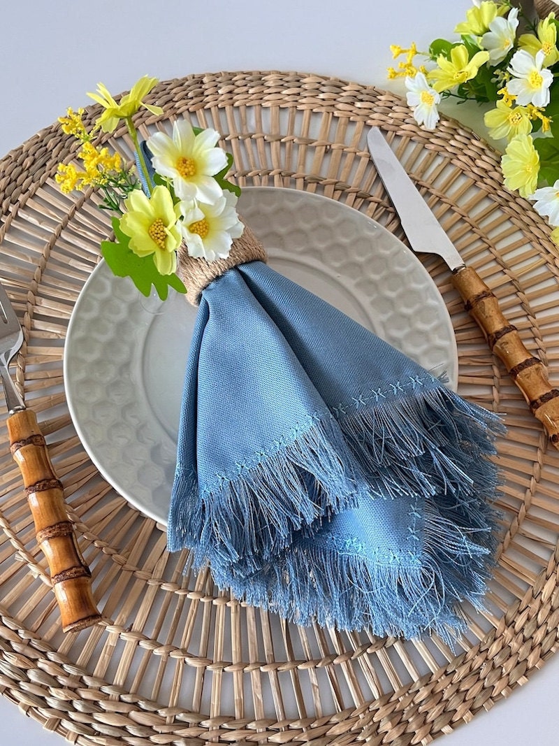 Blue fringe napkin on a table setting for spring.