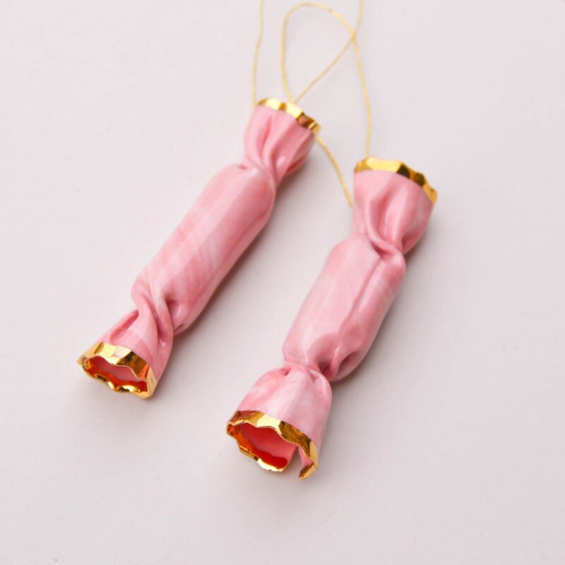Two pink holiday popper ornaments