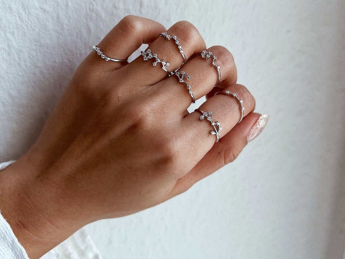 A hand modeling silver constellation rings — a unique birthday gift for her from Etsy.