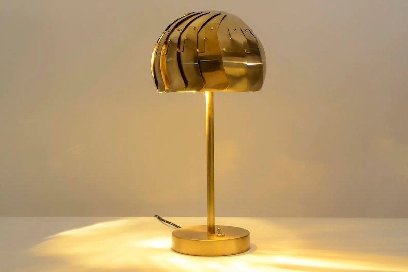 Brass dome bedside table lamp with repositionable light beam