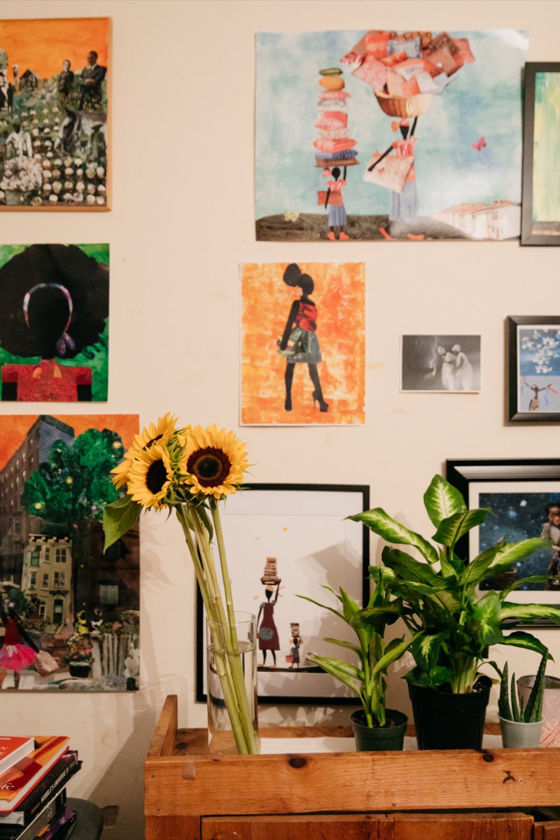 Mirlande's dining room studio wall, decorated with her colorful prints.