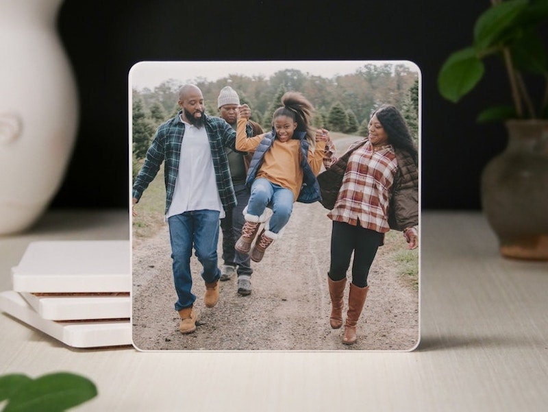 A custom ceramic coaster featuring a family photo.