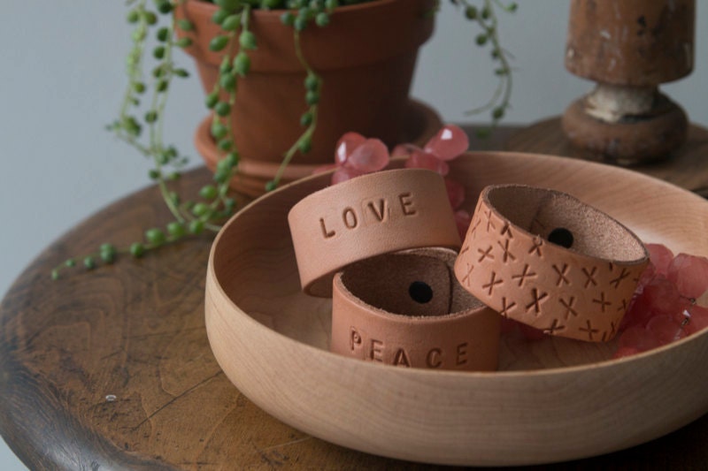 Finished stamped cuffs styled in a bowl.