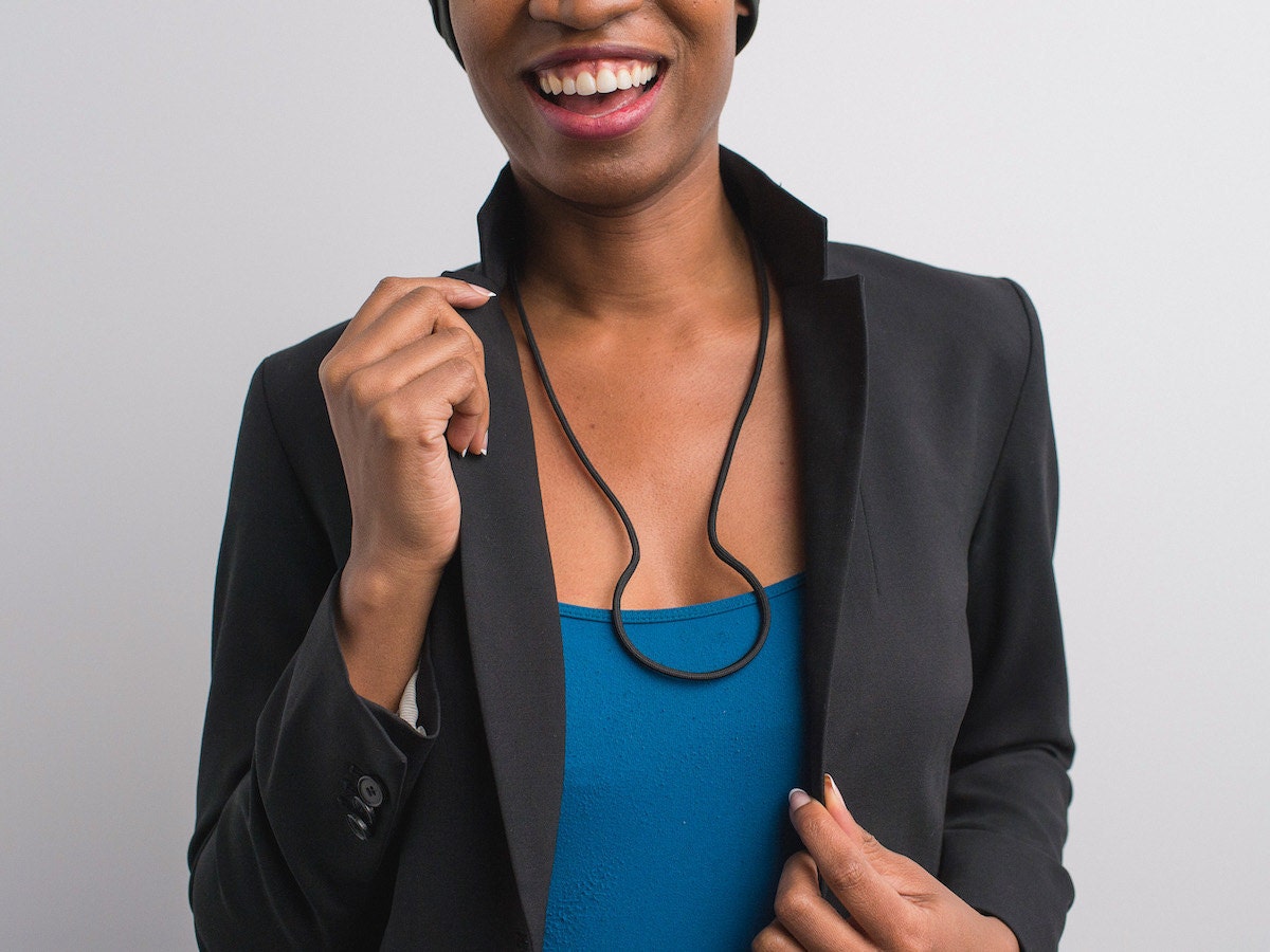A model wearing a DIY paracord necklace bent in a circular shape. A model wearing a DIY paracord necklace bent in a circular shape.