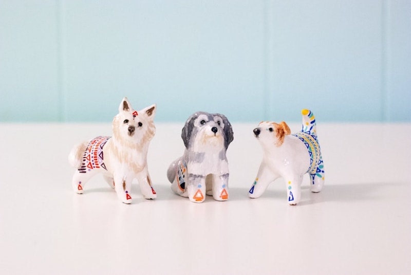 Three mini dog figurines painted in bright colors.