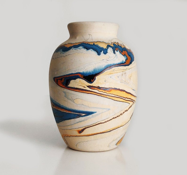 Large Nemadji pottery vase with blue, orange, and red swirls.