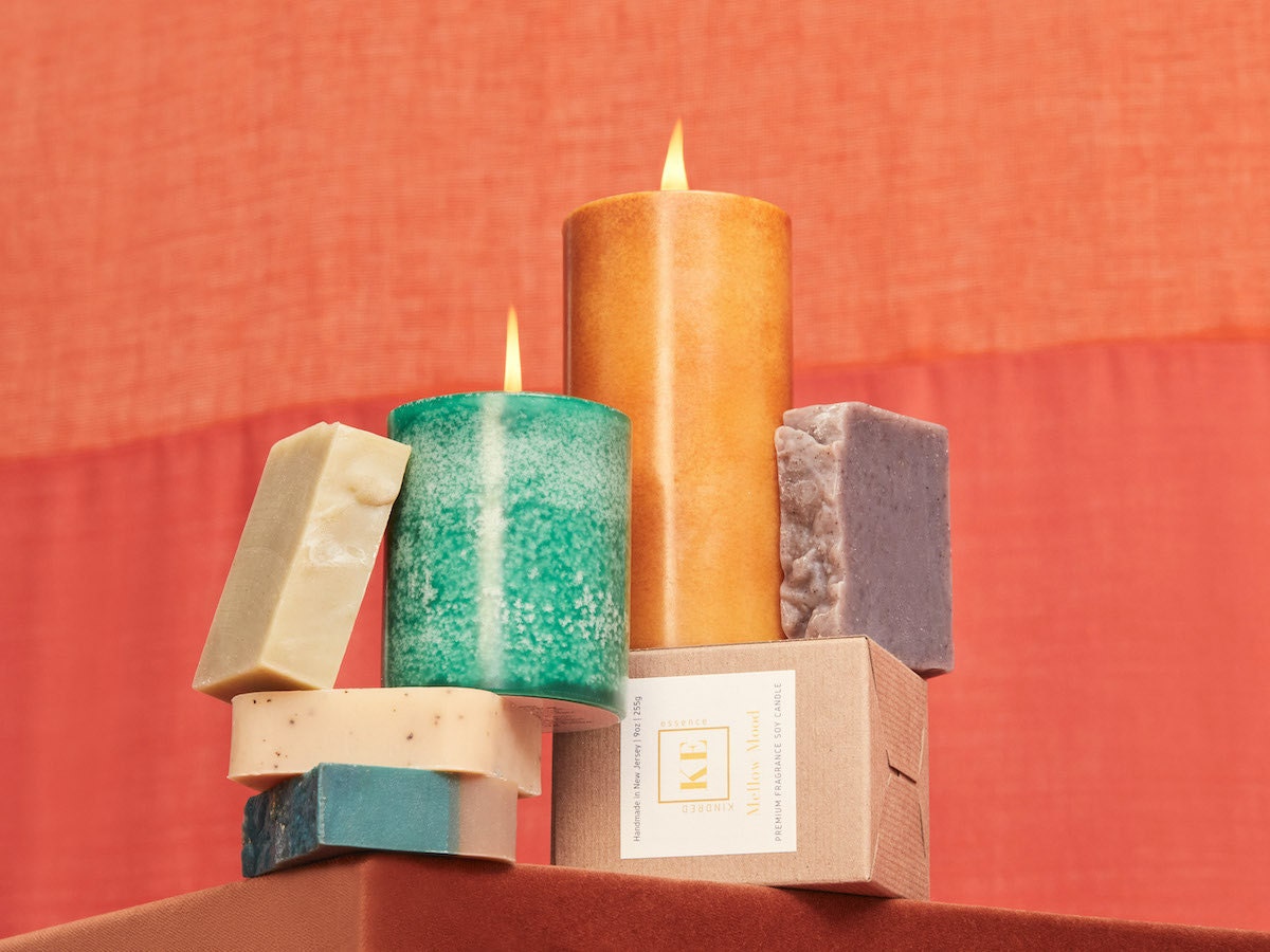 A colorful stack of scented candles and soaps from Kindred Essence A colorful stack of scented candles and soaps from Kindred Essence