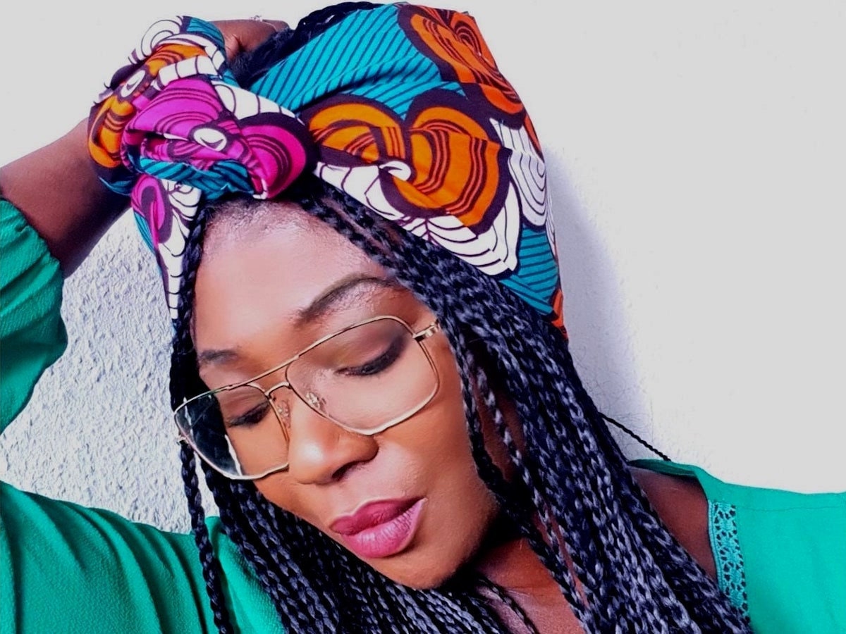 A woman modeling an Ankara-print headwrap.