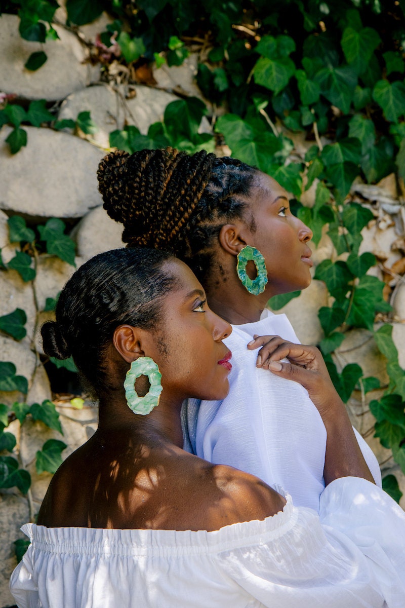 Women modeling earrings from Atiwo Designs on Etsy.