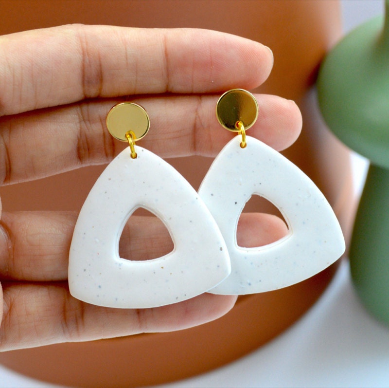 Triangular clay earrings from Pache Studio, a Black-owned shop on Etsy.