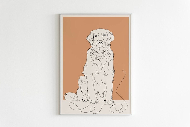 A framed custom digital illustration of a labrador dog with a muted orange background hanging on a blank wall.
