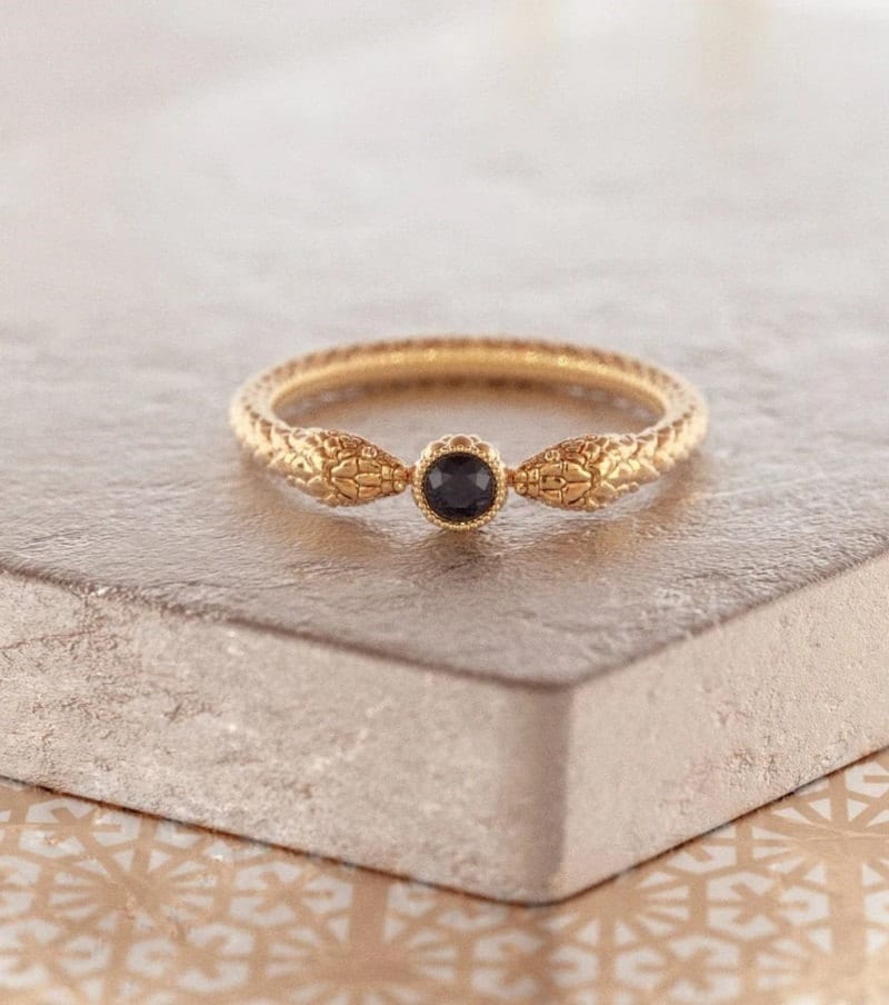 Gold snake ring with round black diamond