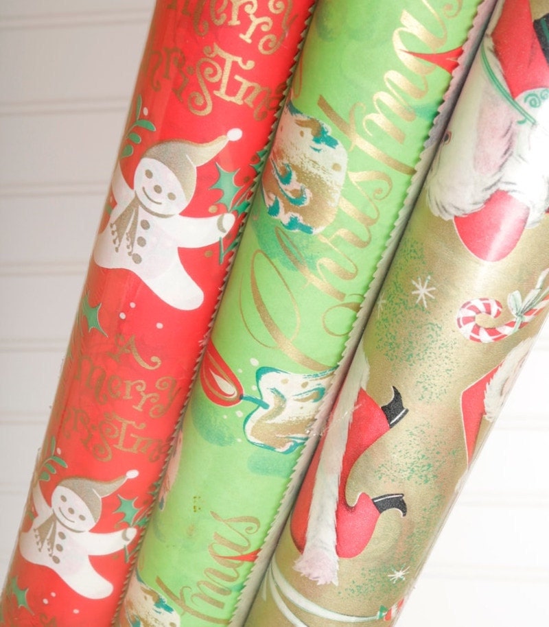 Three rolls of vintage Christmas wrapping paper.