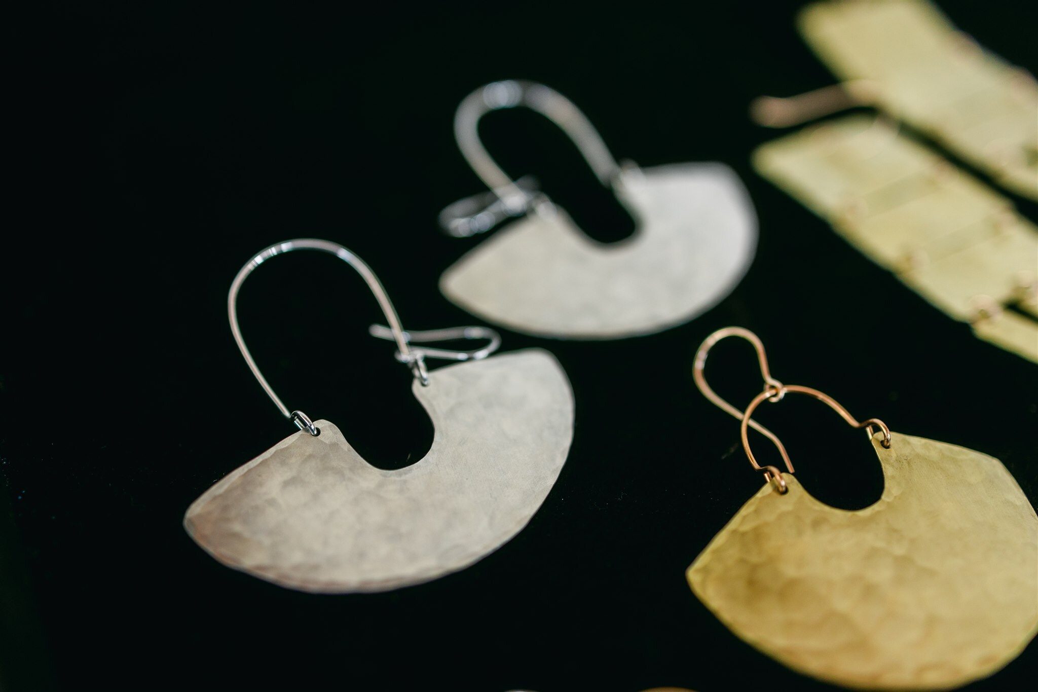 Mini goddess shield earrings from Enarmoured in brass and silver.