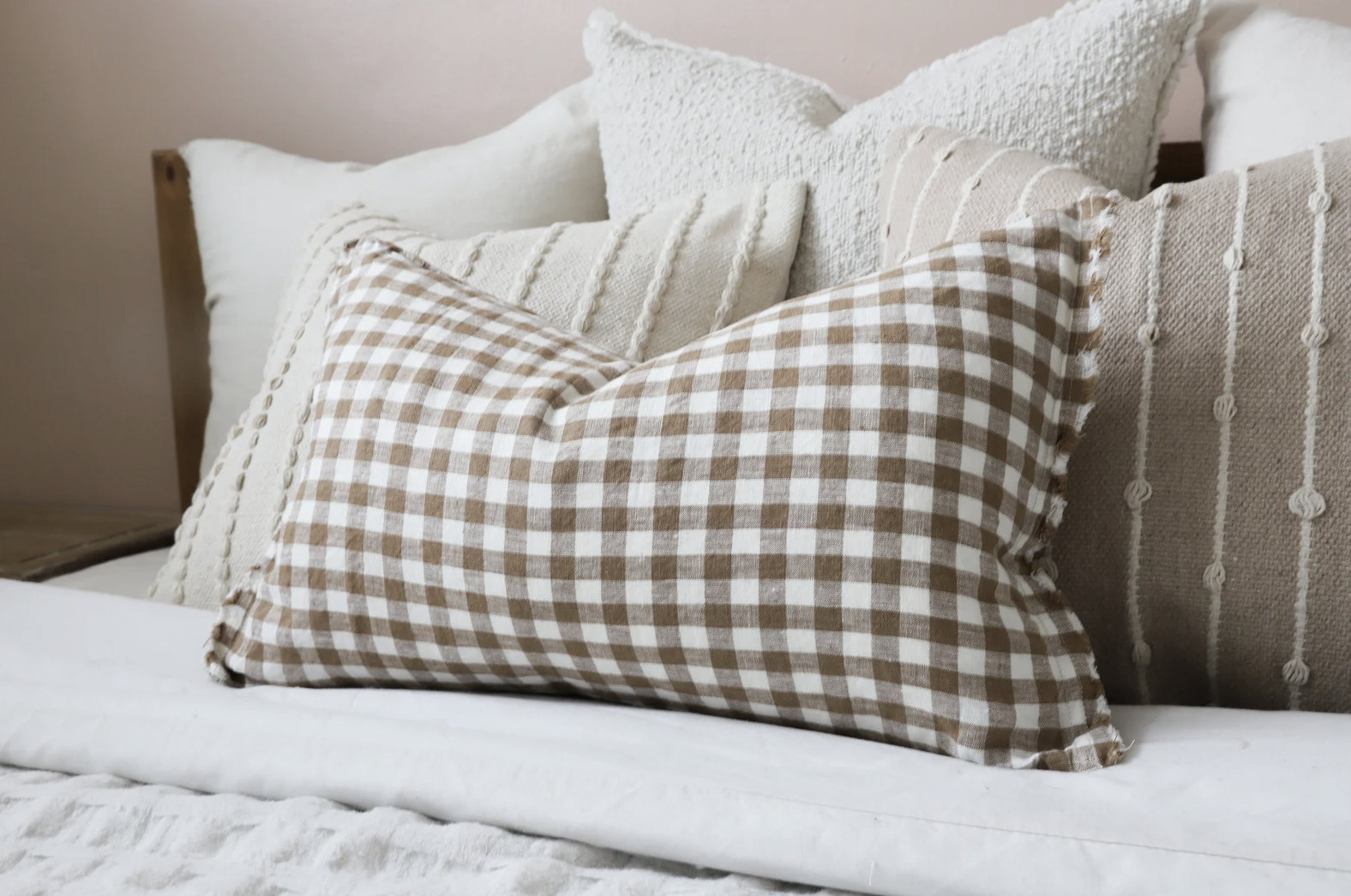 Beige gingham pillowcase in a comfy looking pile