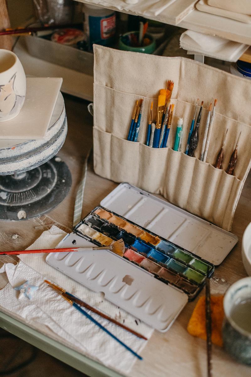 Studio scene with paint brushes and paint set.
