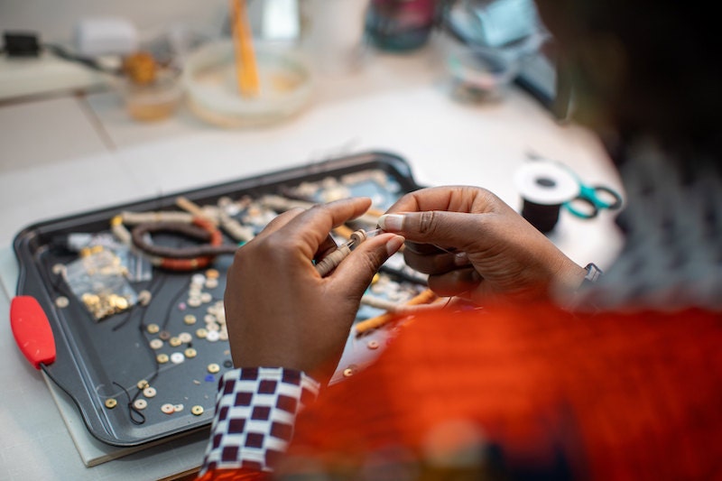 Dorianne from Atiwo Designs making jewelry in her studio.