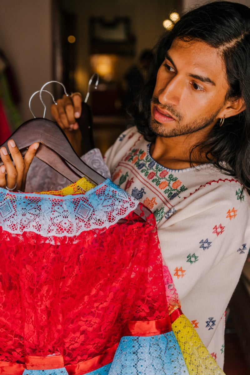 Jesus shows the quality of the lacework on some vintage Mexican dresses.