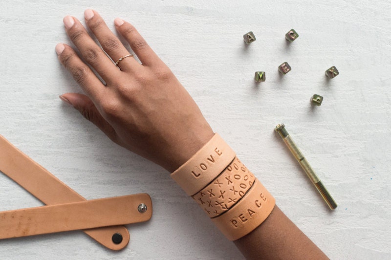 A hand modeling finished stamped cuffs.