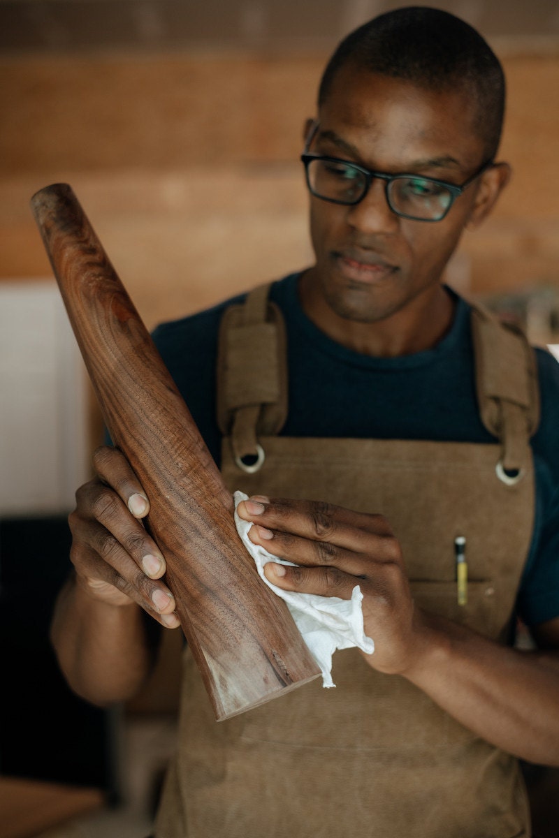 Photo of Kwadwo working on a table leg