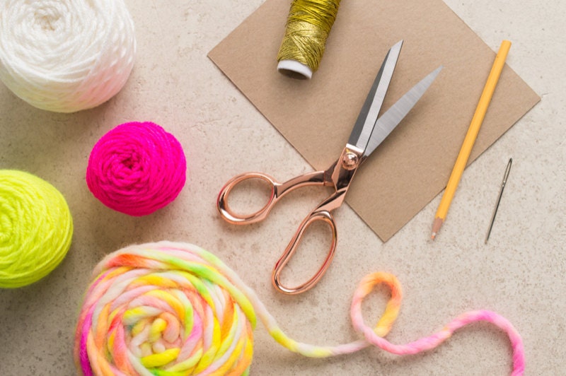 A flat-lay of materials needed to create DIY tassels. A flat-lay of materials needed to create DIY tassels.