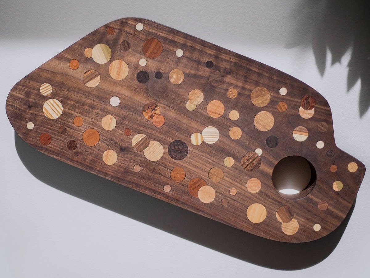 A polka-dot wooden cutting board from Untitled Co on Etsy. A polka-dot wooden cutting board from Untitled Co on Etsy.