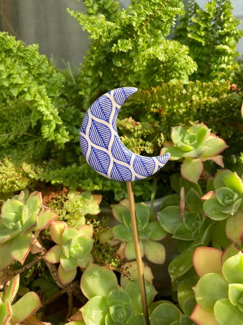 Ceramic moon plant stake from Etsy