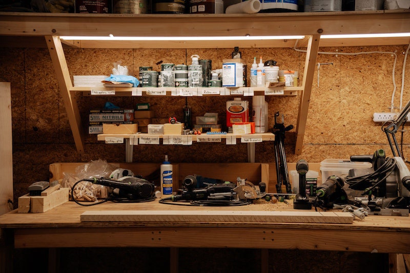 Photo of workspace with shelves of tools and materials