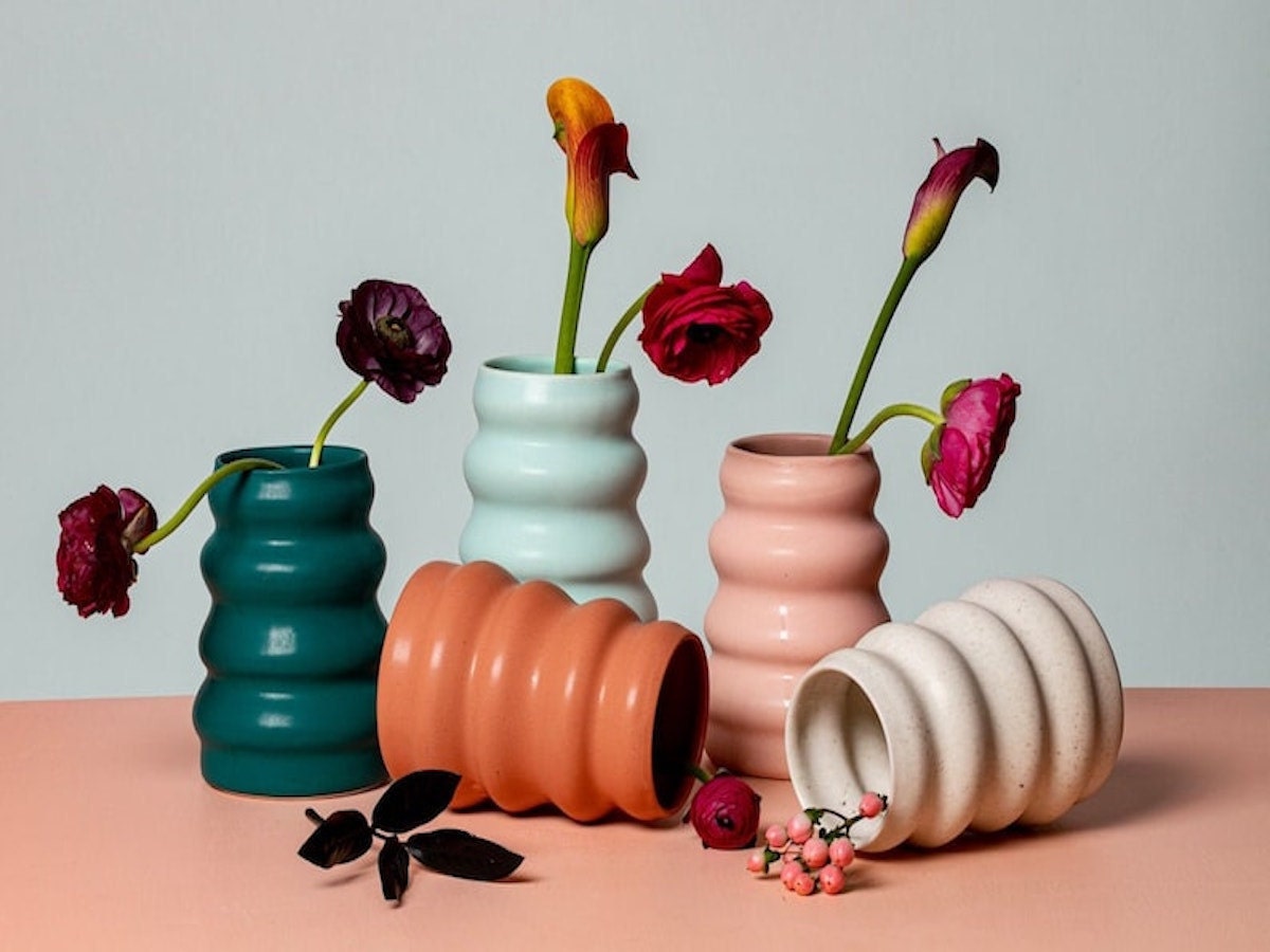 Best housewarming gift ideas: an image showing numerous modern handmade ceramic flower vases in muted colors from Etsy