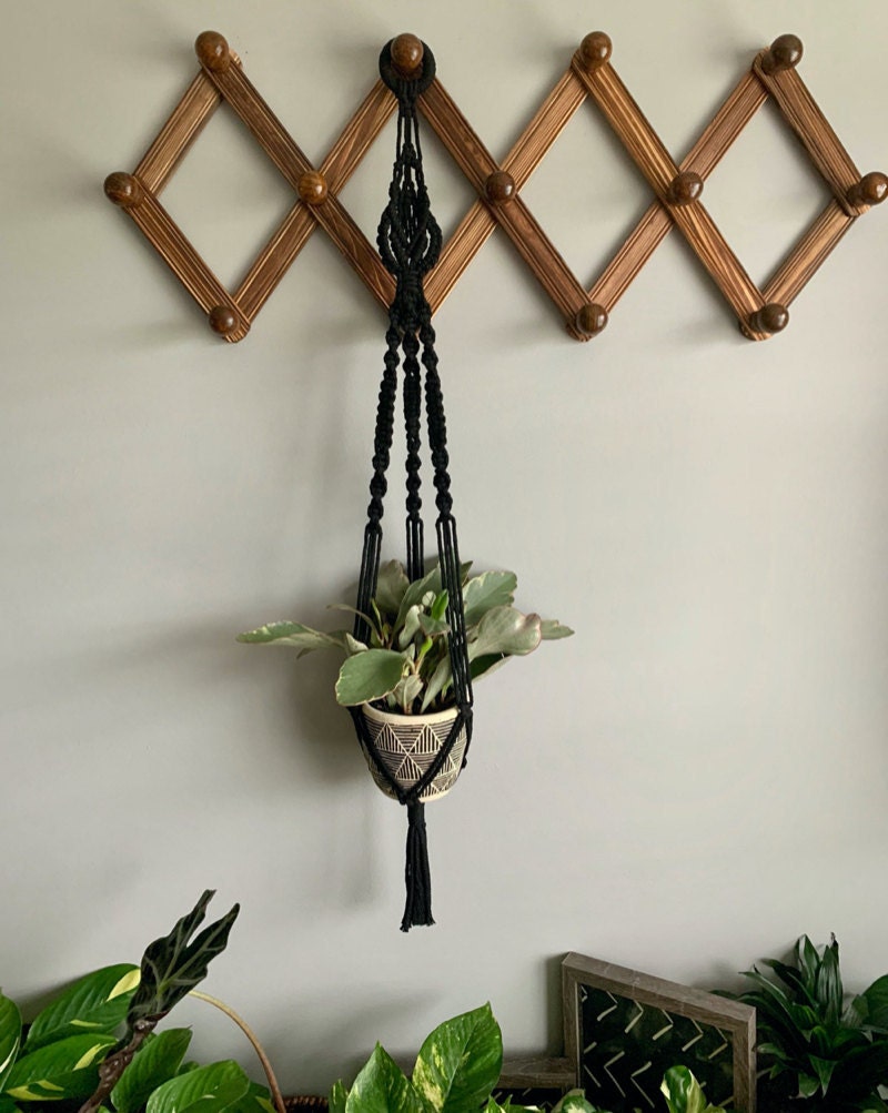 A macrame plant hanger from Knot a Game, a Black-owned shop on Etsy.