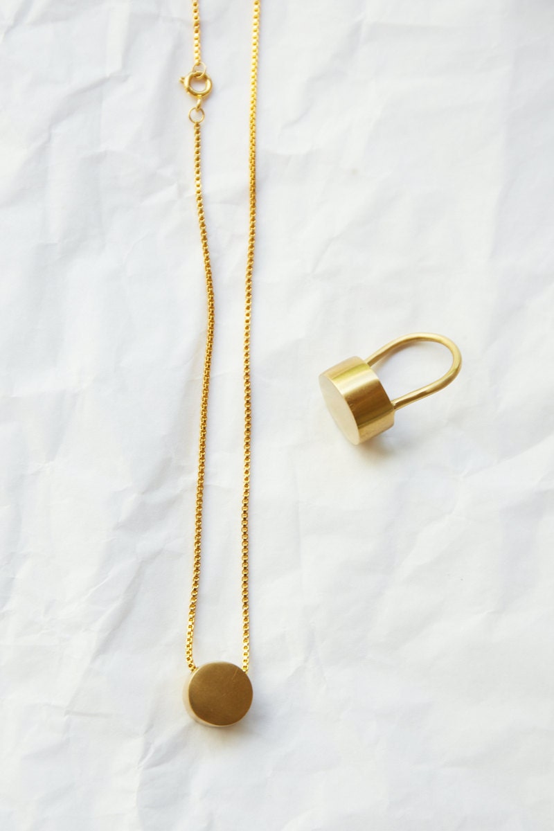 A matching bronze dot necklace and ring.