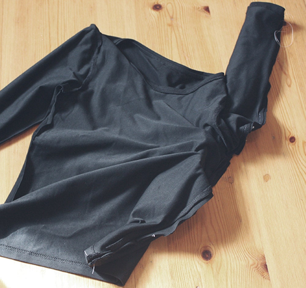 Preparing to add the arm of a DIY bat costume Preparing to add the arm of a DIY bat costume