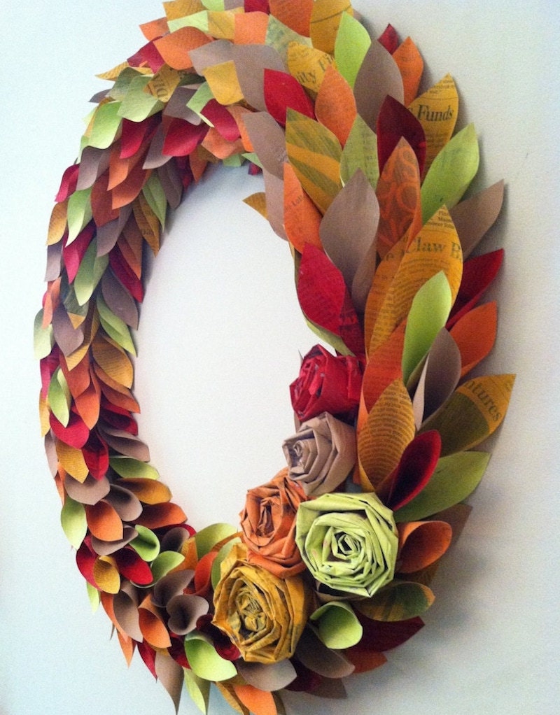A homemade fall wreath made from painted newspaper clippings in oranges, reds, browns, and greens.