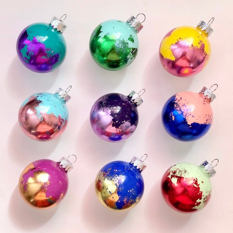 Numerous multicolors gold leaf holiday ornaments.