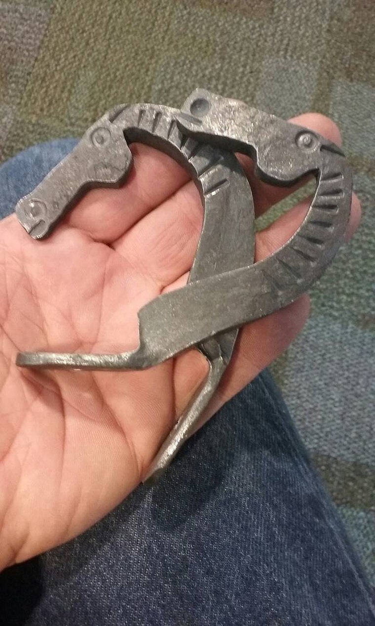 Forged horse-head piece held in an open hand