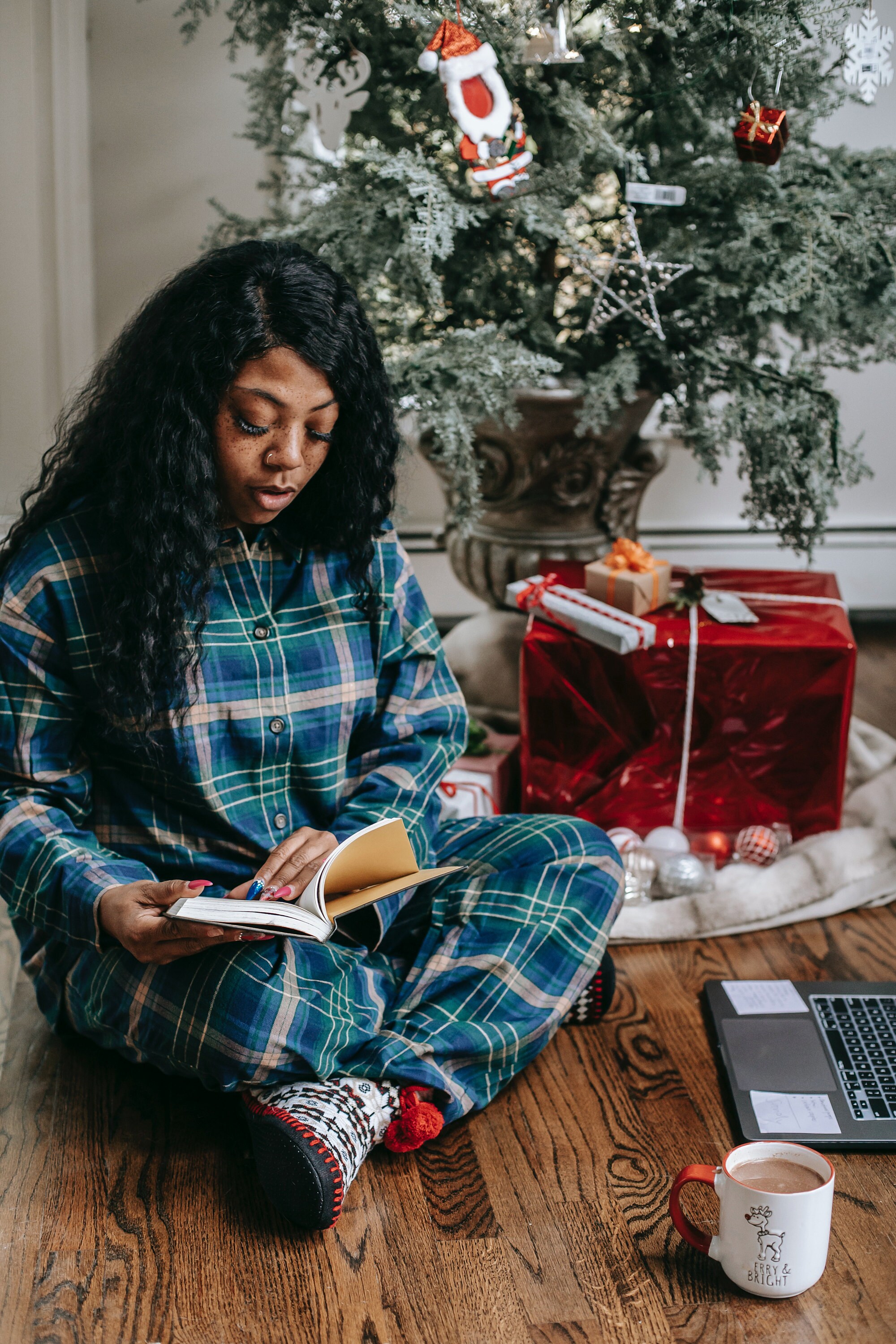 Photo by Any Lane: https://www.pexels.com/photo/focused-black-woman-reading-book-under-christmas-tree-5728323/