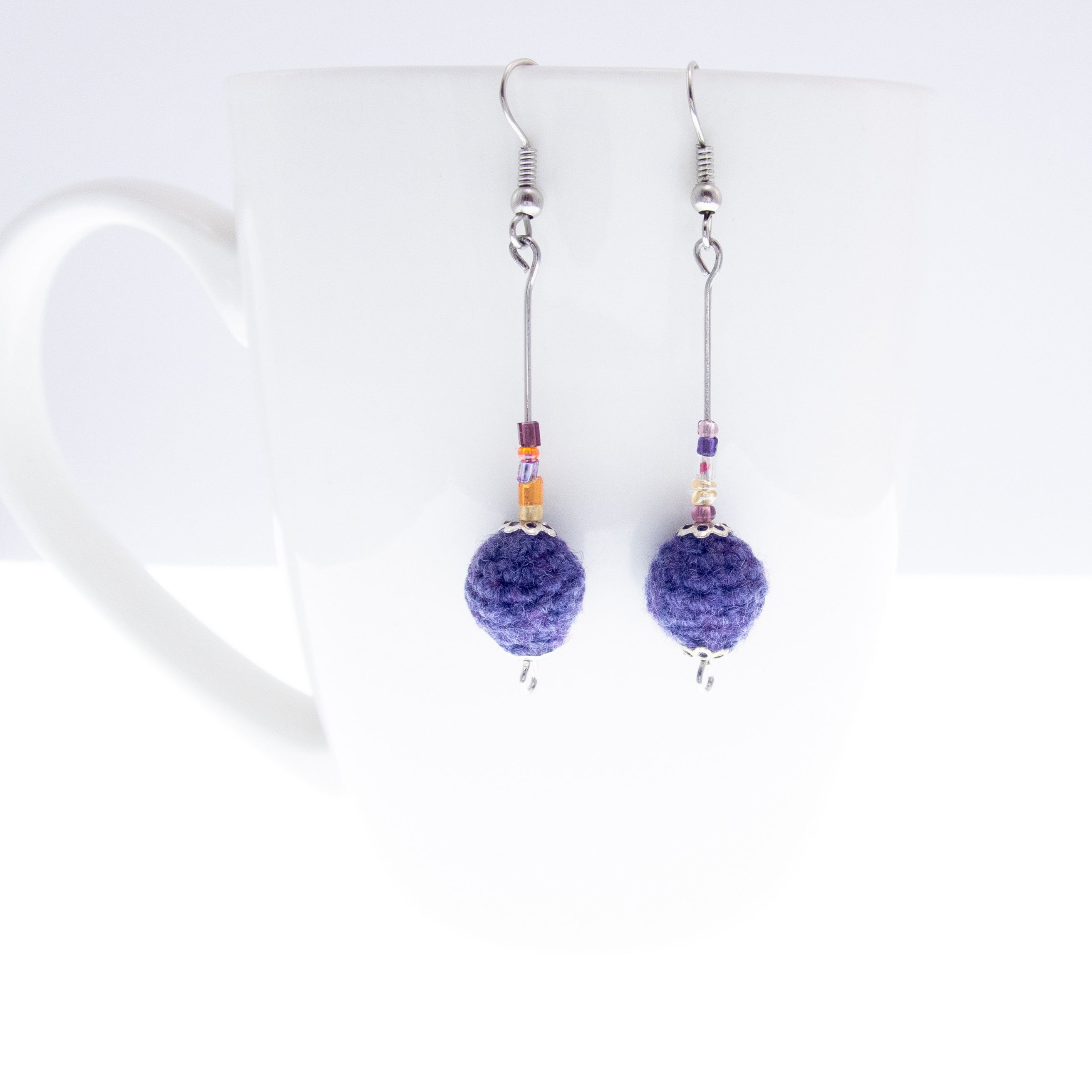 handmade statement earrings dangle with knitted purple balls
