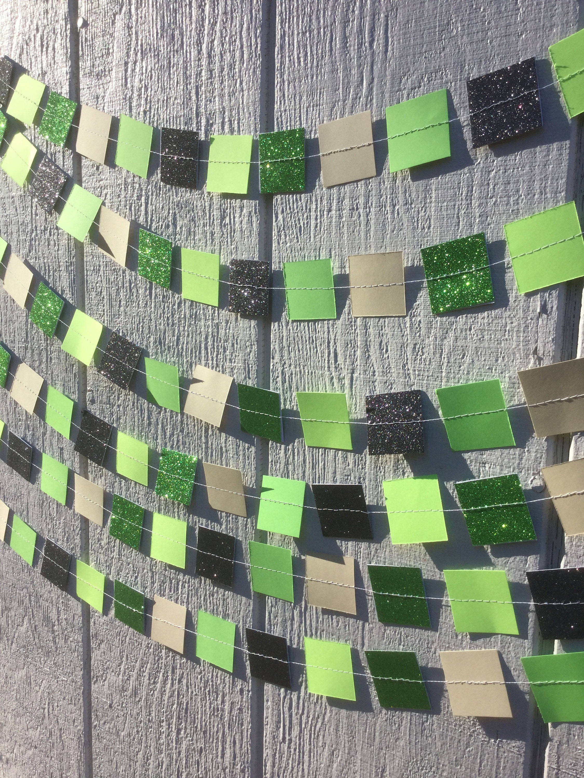 green and black glitter and green and brown paper squares sewn into a Minecraft garland