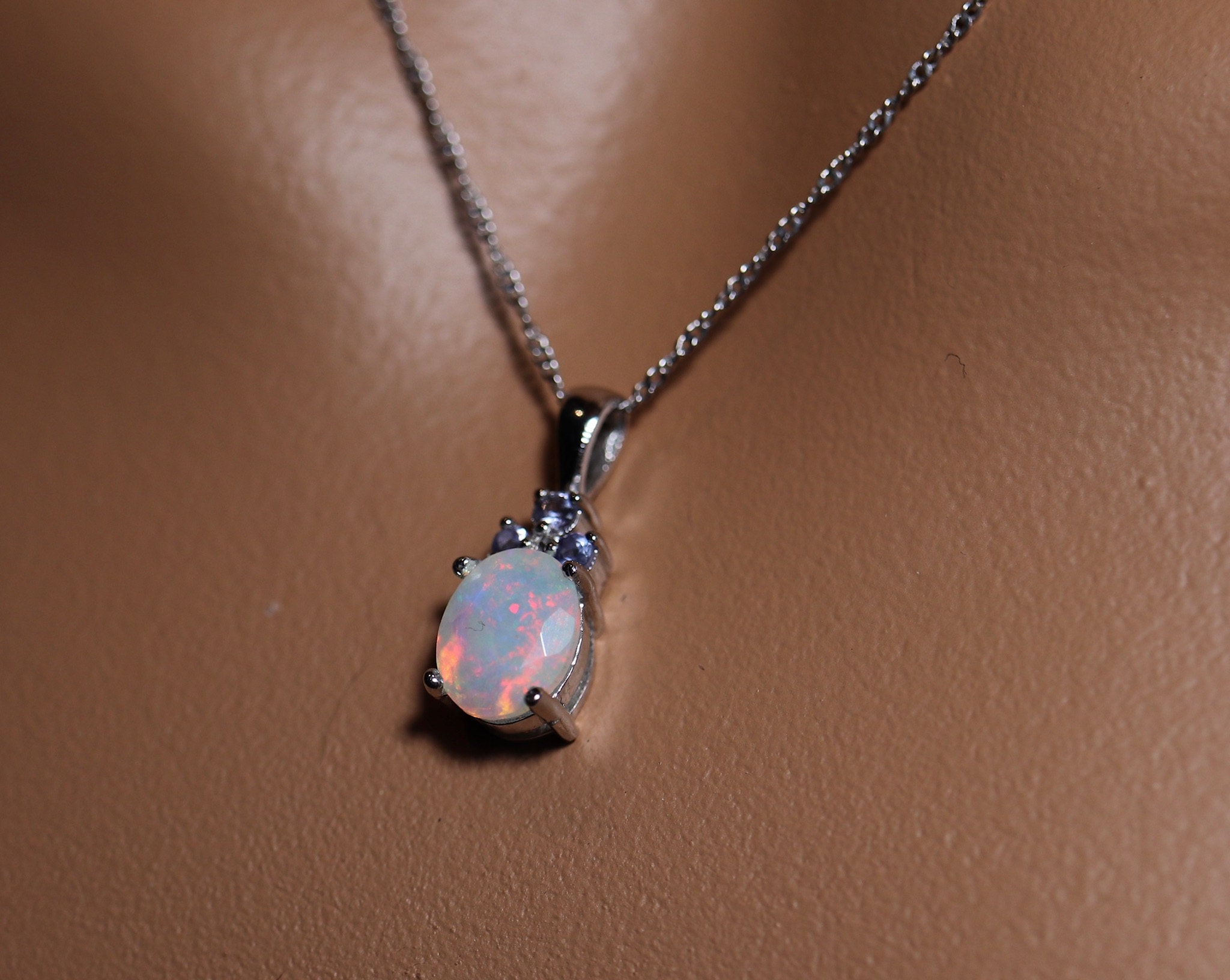9x7mm white base with pink fire and natural tanzanite accents