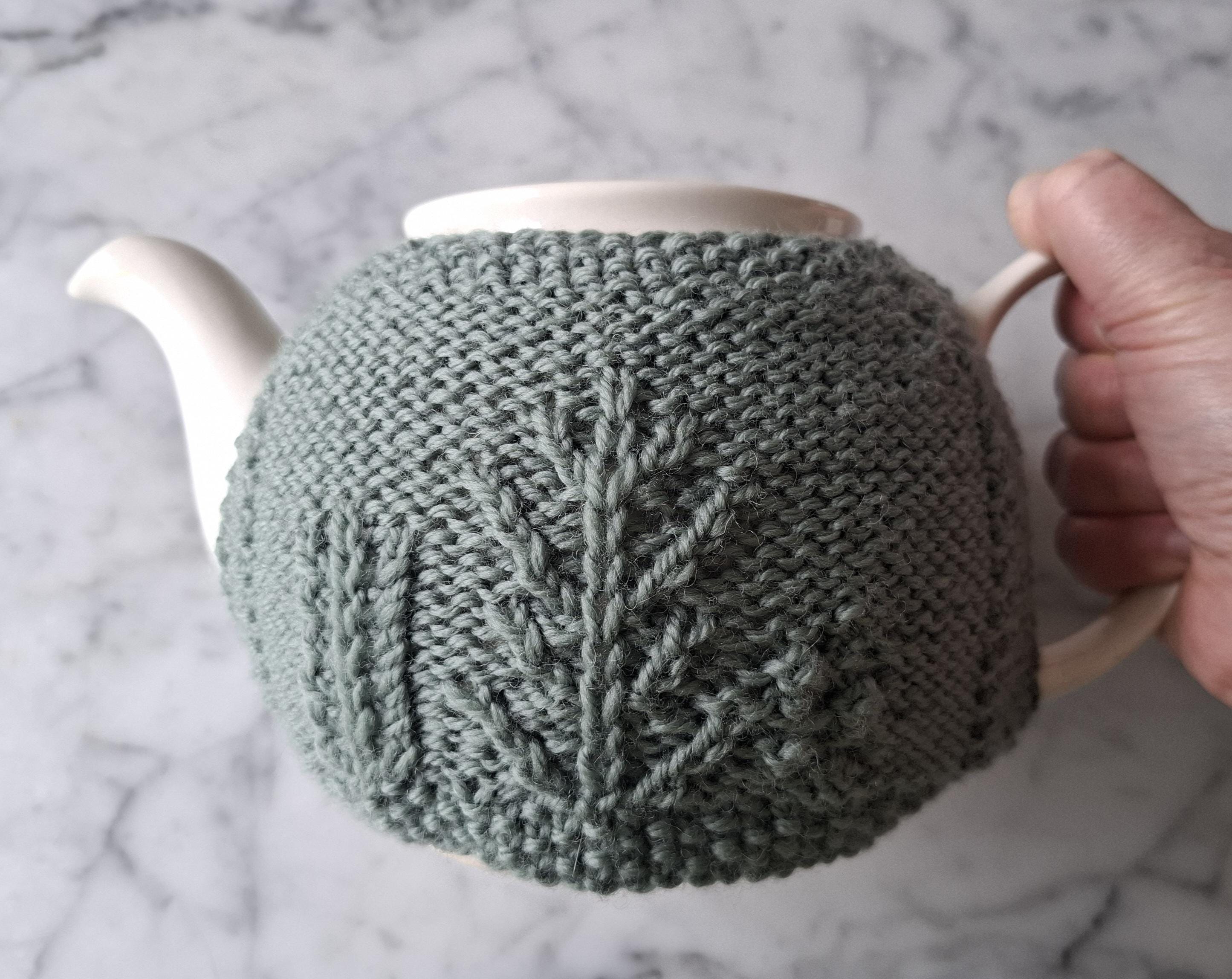 Green teacosy with forest tree cable pattern