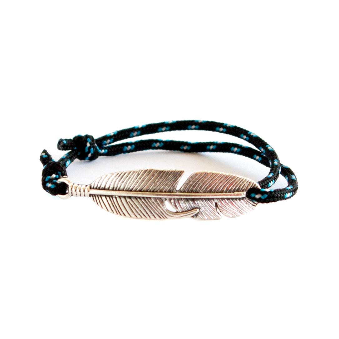 Minimalist feather charm bracelet by Nadamlada, designed for everyday outdoor-inspired wear.