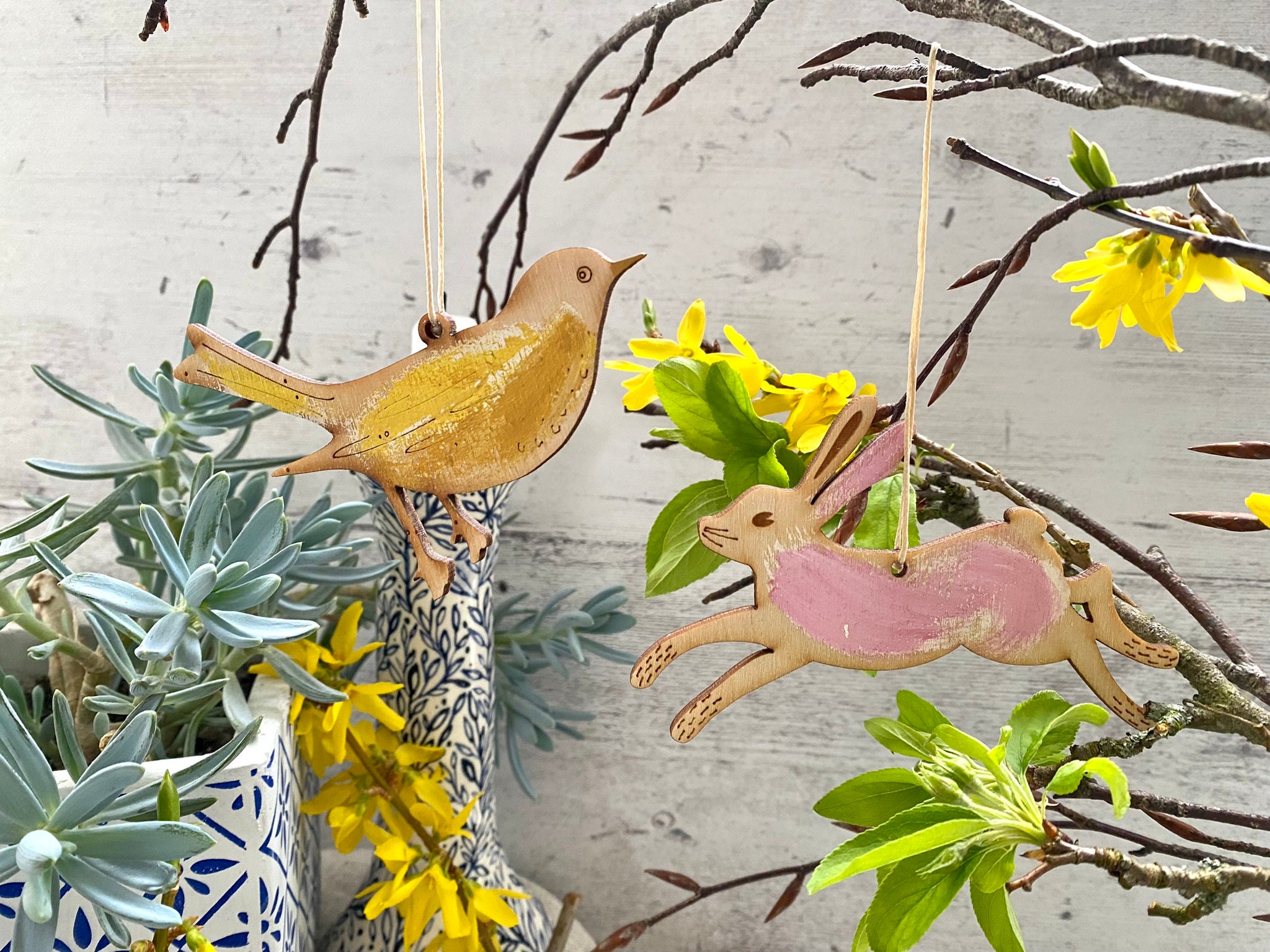 Easter decorations- a Wooden Bird and a Wooden Hare displayed on a branch