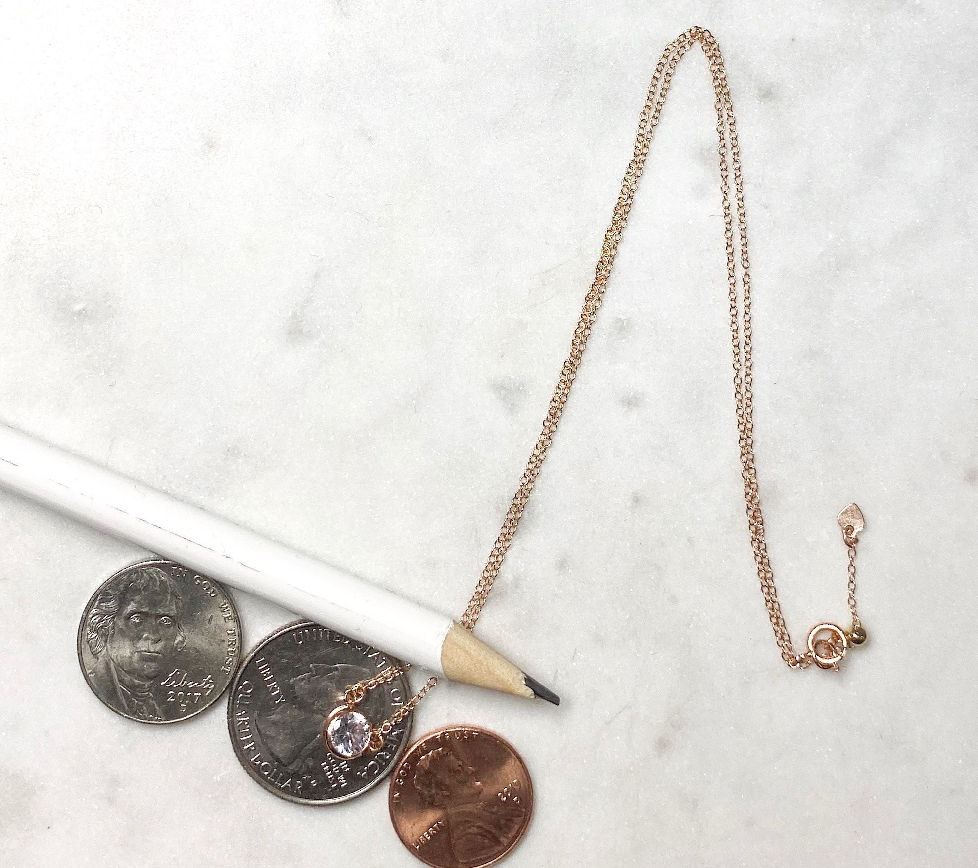 14K rose gold filled version features a tiny heart charm at the back vs the gold version which features our minu cz charm in the back