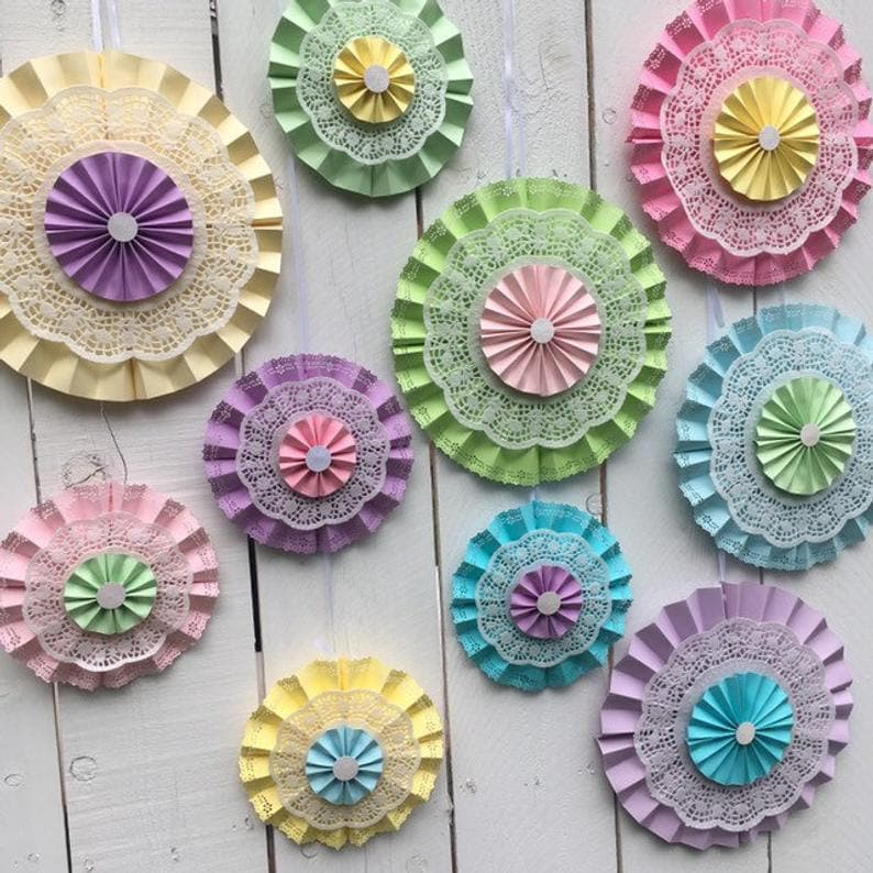 pastel pink mint yellow baby blue lavender paper fans with lace and doilies to use for a backdrop photo shoot