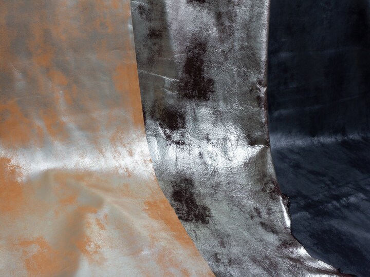 Three hides of leather including gold foil, copper foil, and blue metallic.