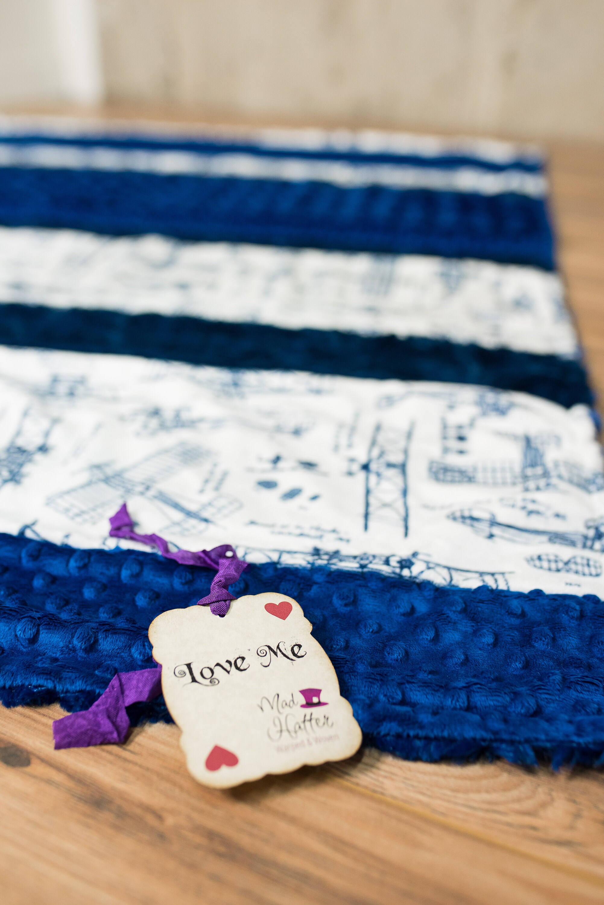 Mad Hatter Warped & Woven Minky Blanket with strips of blue and gray minky and patterned fabric