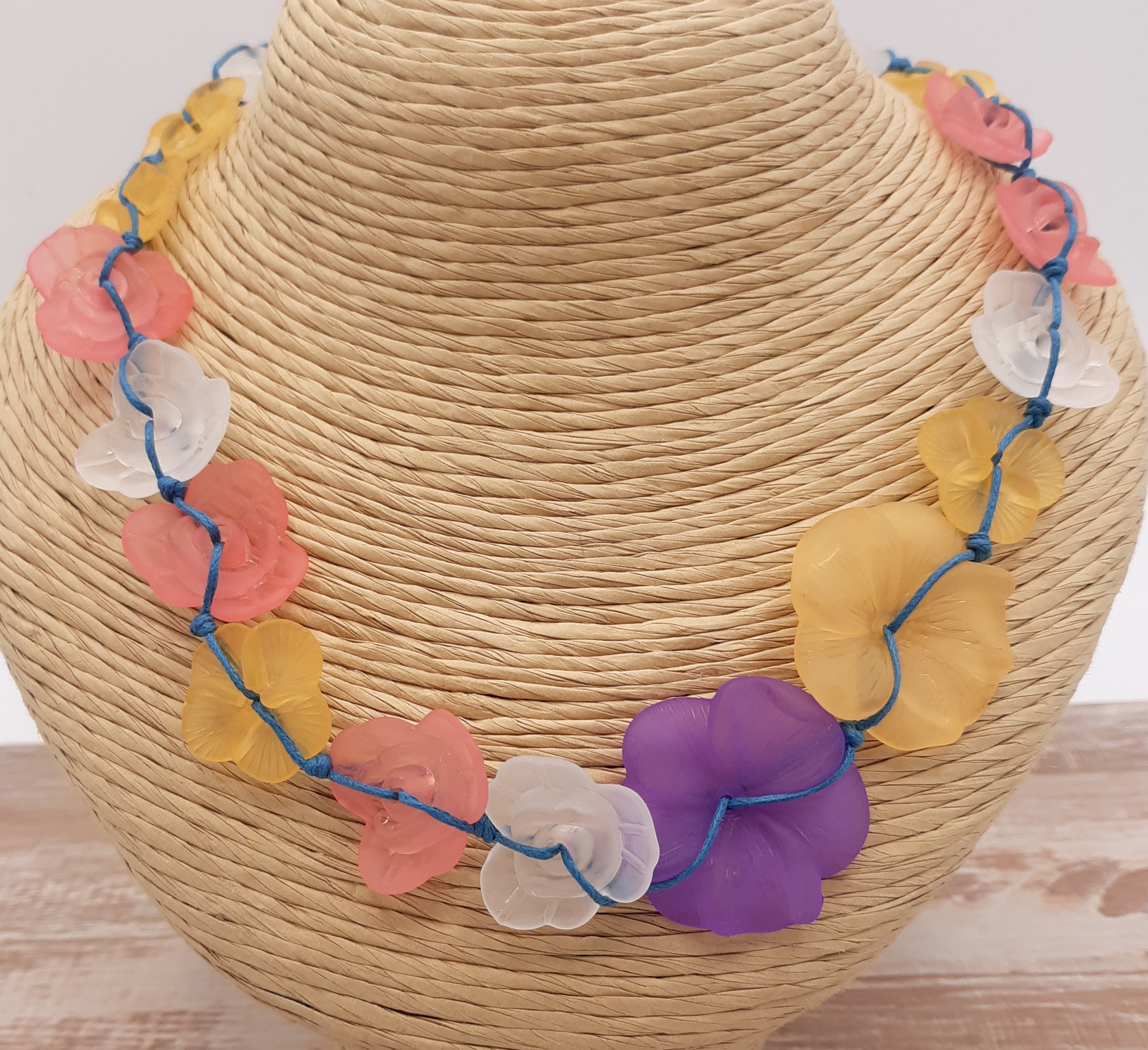 different color and sizes acrylic flowers hand knotted on blue cotton cord