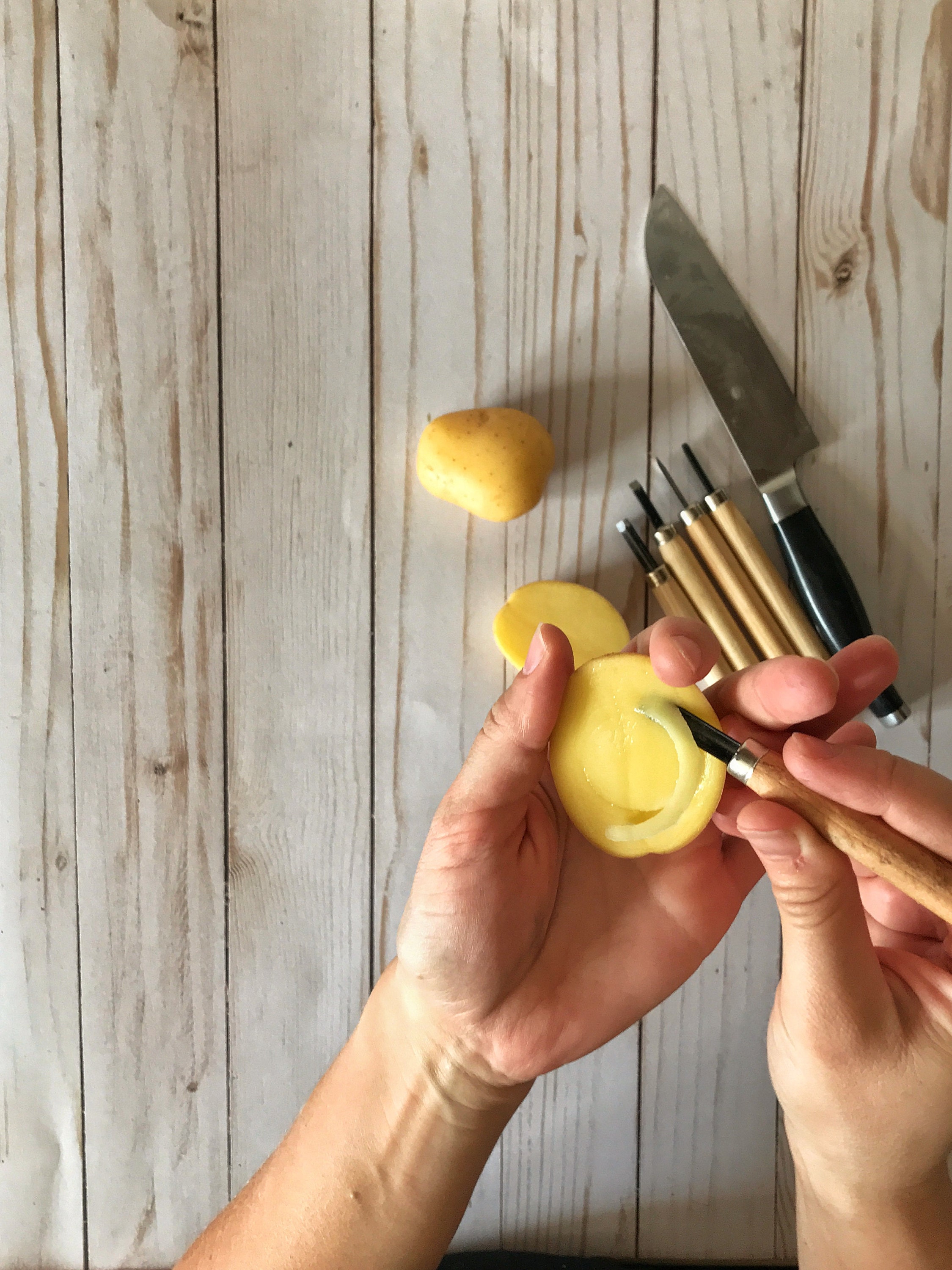 carving a stamp from a potato