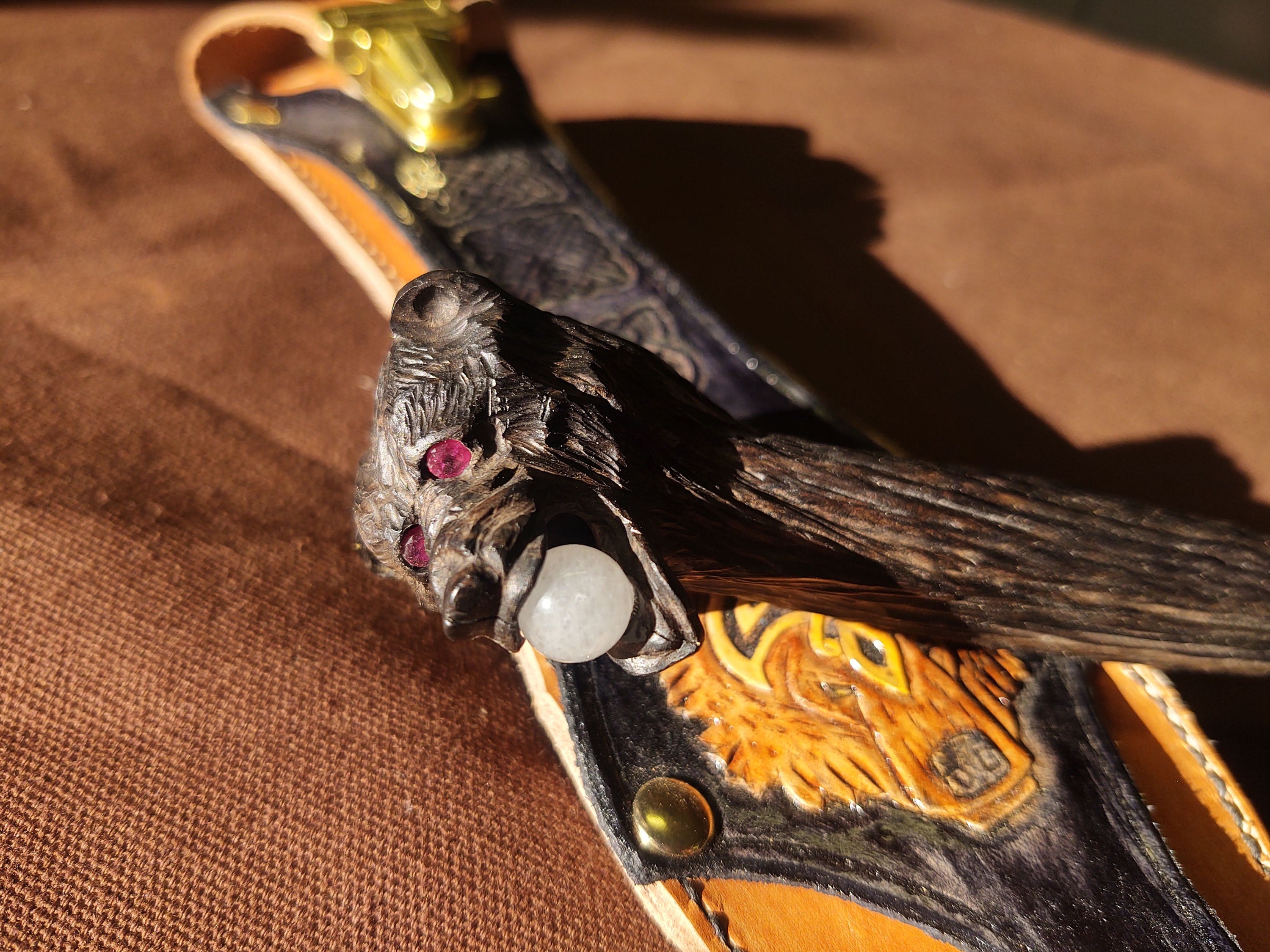 Ruby eyes and a Smokey quartz ball carefully set in the mouth.