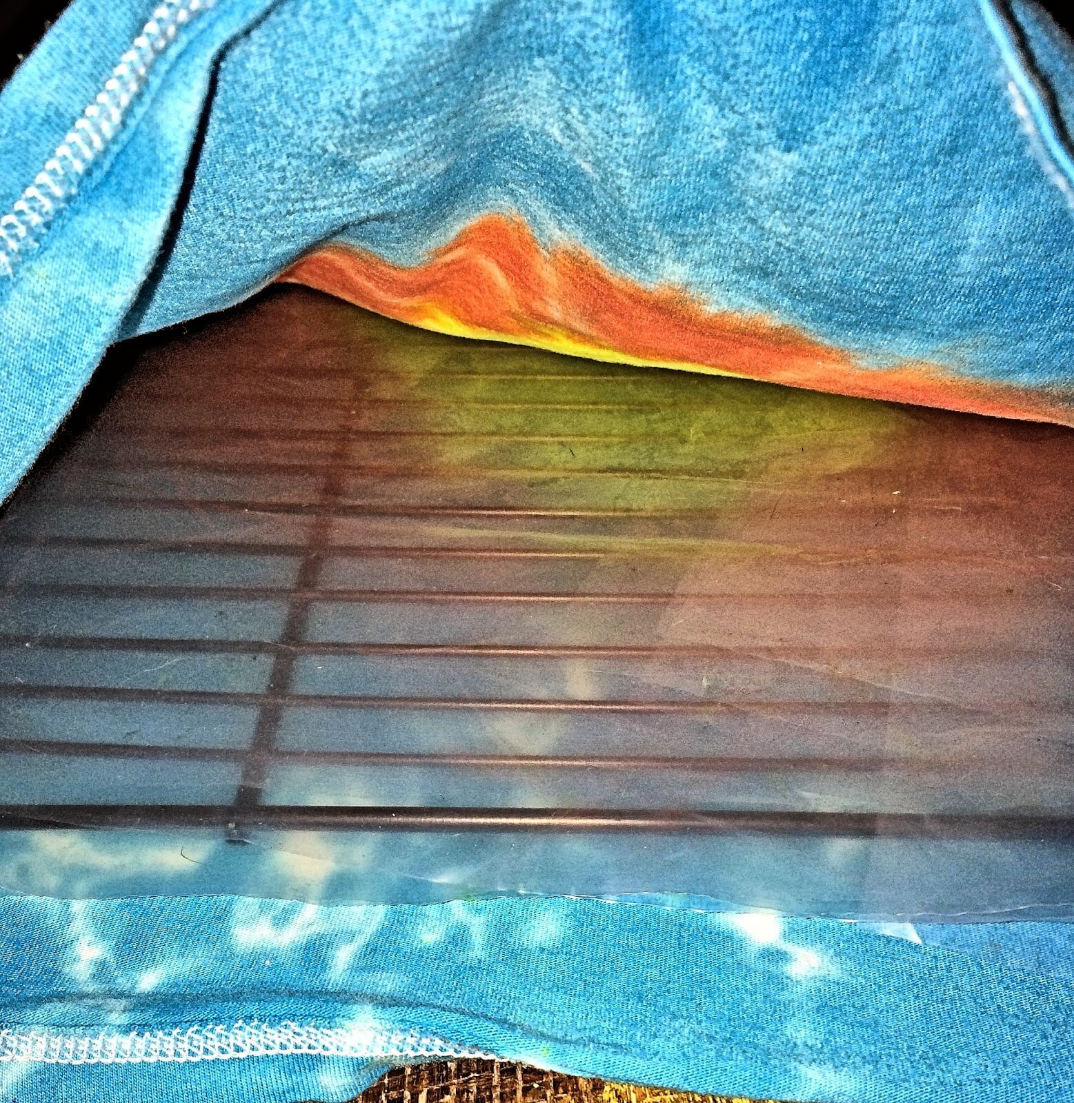 Drying rack and plastic placed inside the shirt to prevent paint bleed-through